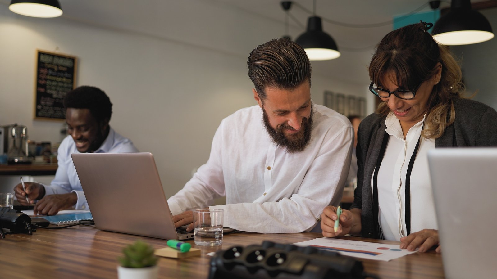 Business team of diverse people doing strategic planning work inside modern office