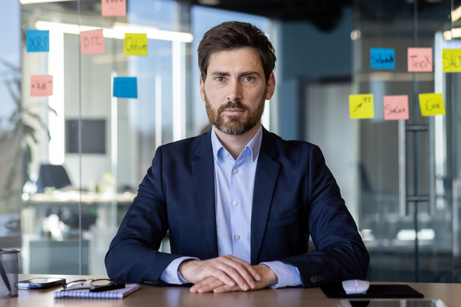 Confident businessman in office with strategic notes