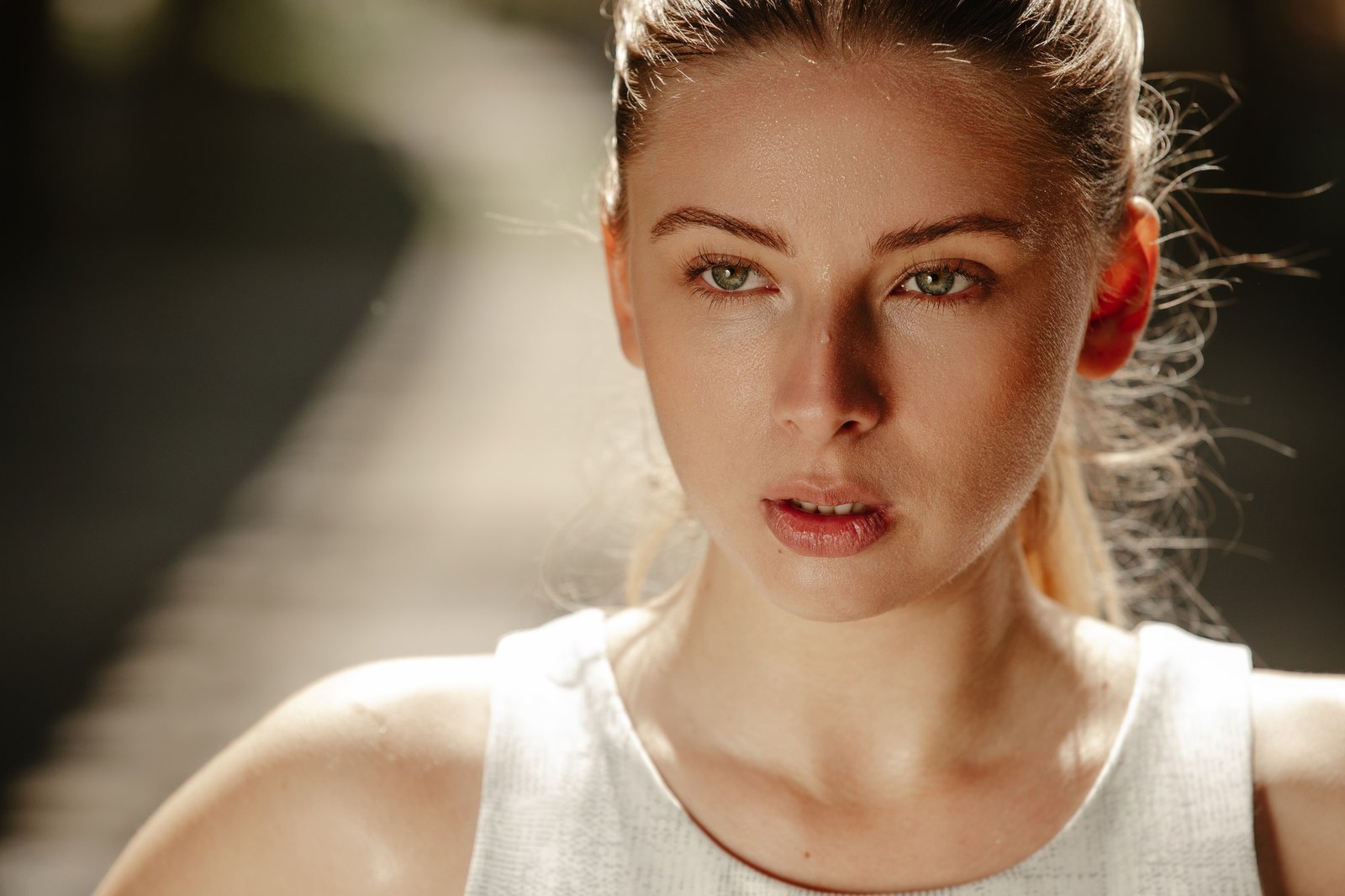 Portrait of beautiful strong fit blond catching her breath after intense fitness training program.