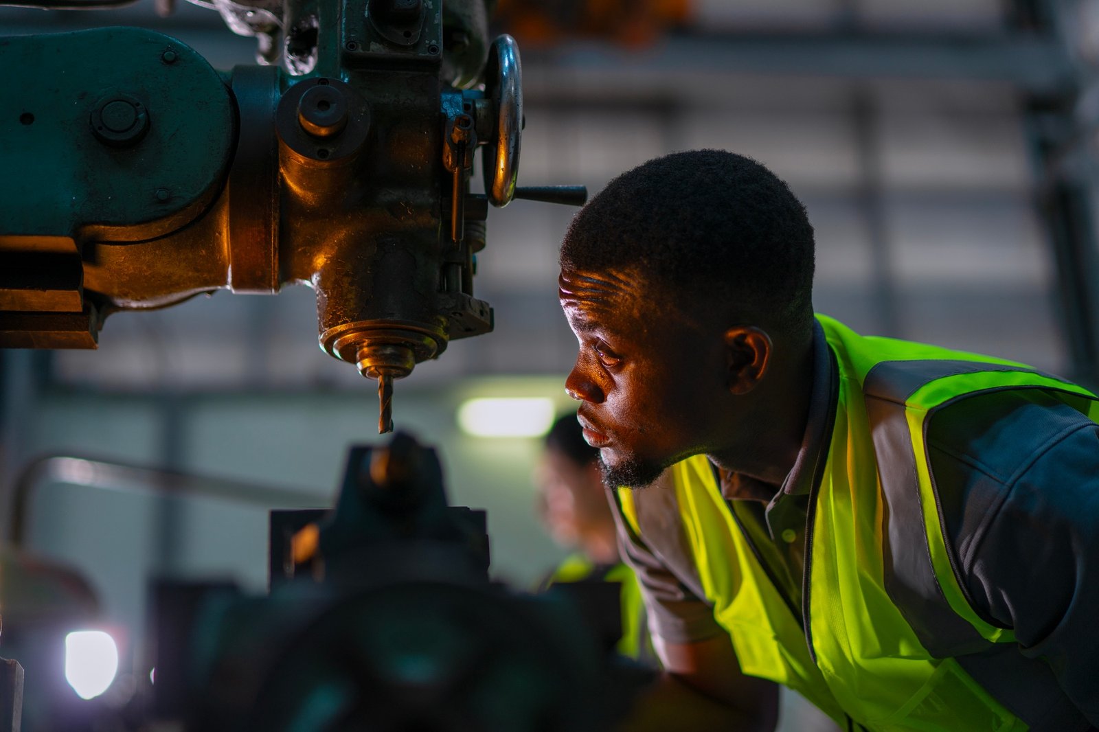 Blue collar workers upskill at lathe machine shop.