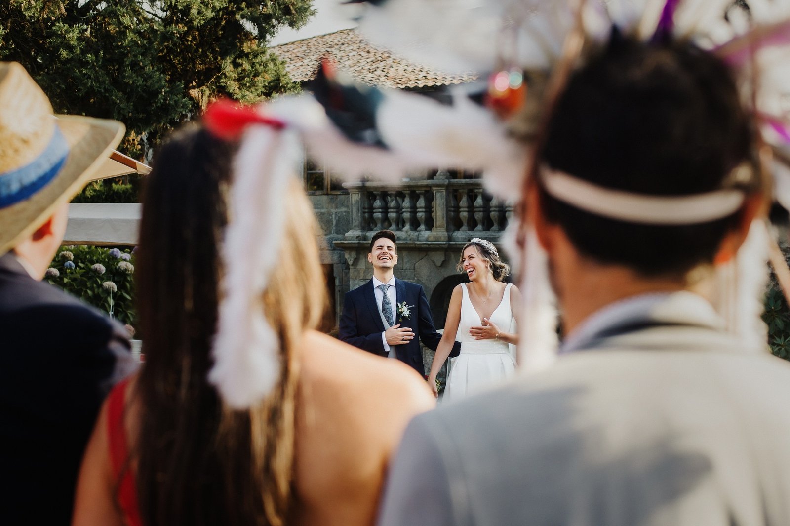 Couple laughing at a wedding with disguised guests