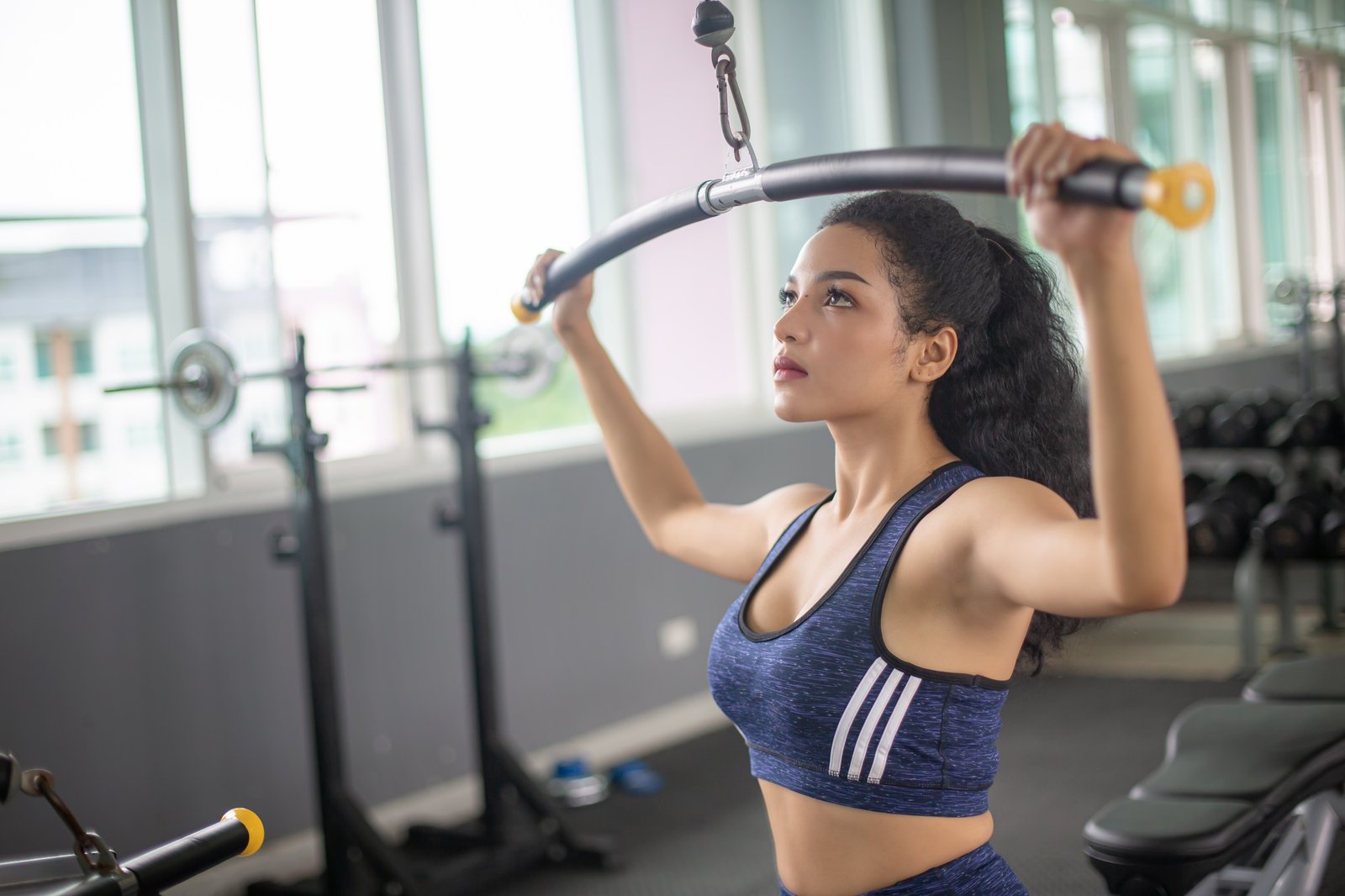 Wasit up image of a fit, young African American woman working out in a fitness gym.