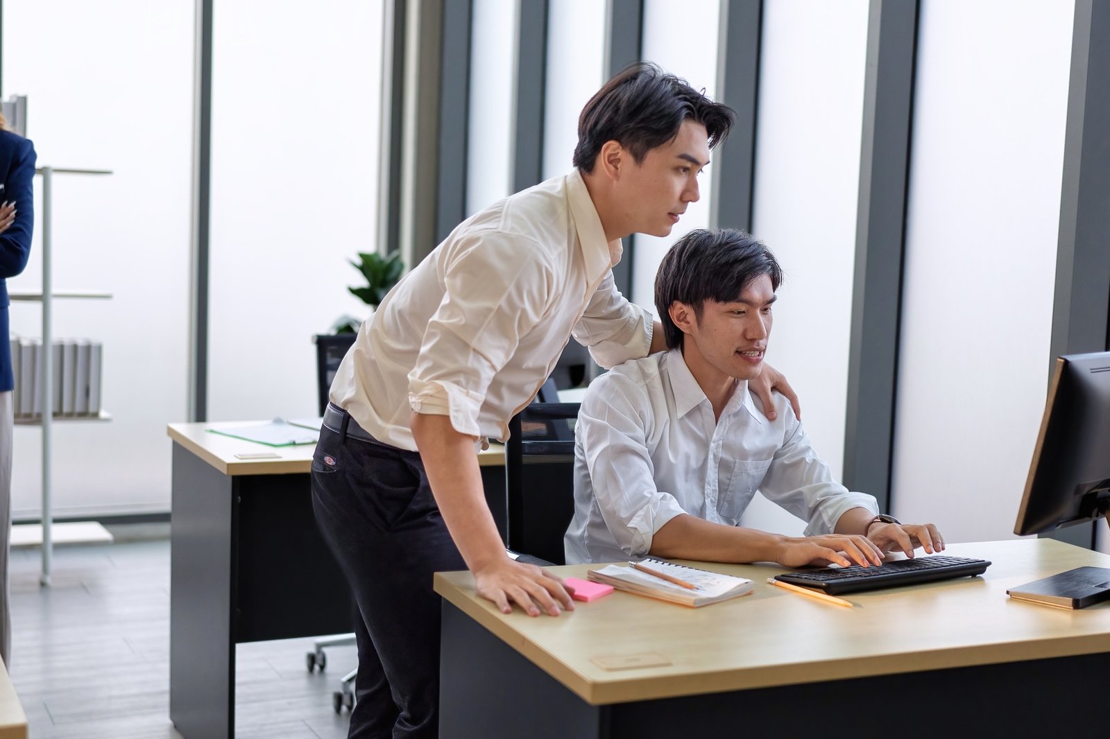 Business employee in office working at table and discussing business strategy together