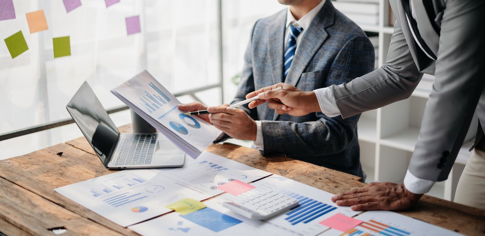 Business People Talking Discussing with financial document data charts and graphs Team business